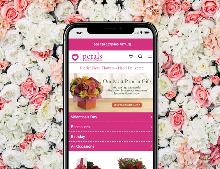 Teleflora website shown on mobile device with flowers in the background