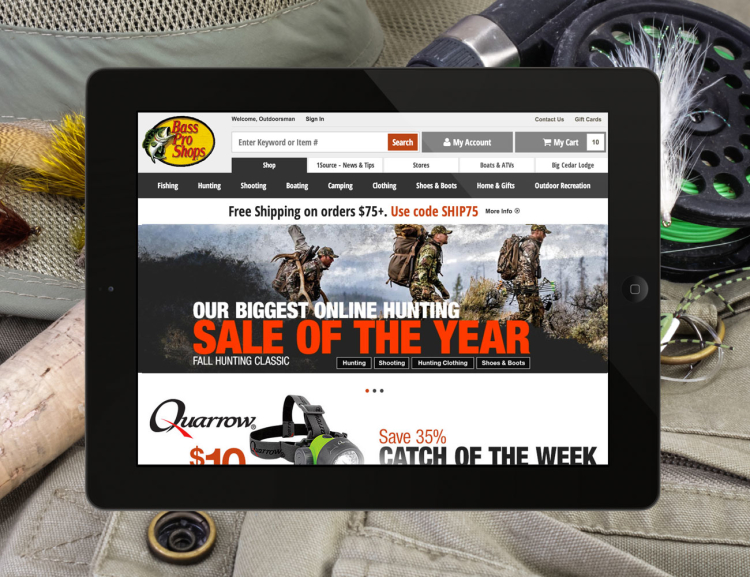 Bass Pro Shops website shown on mobile device with fishing gear in the background