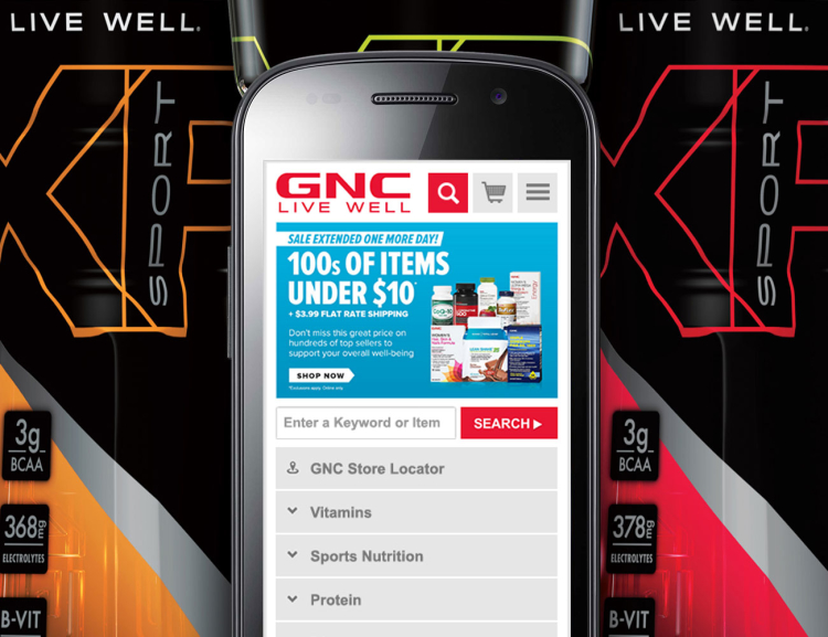 GNC website shown on mobile device with products in the background