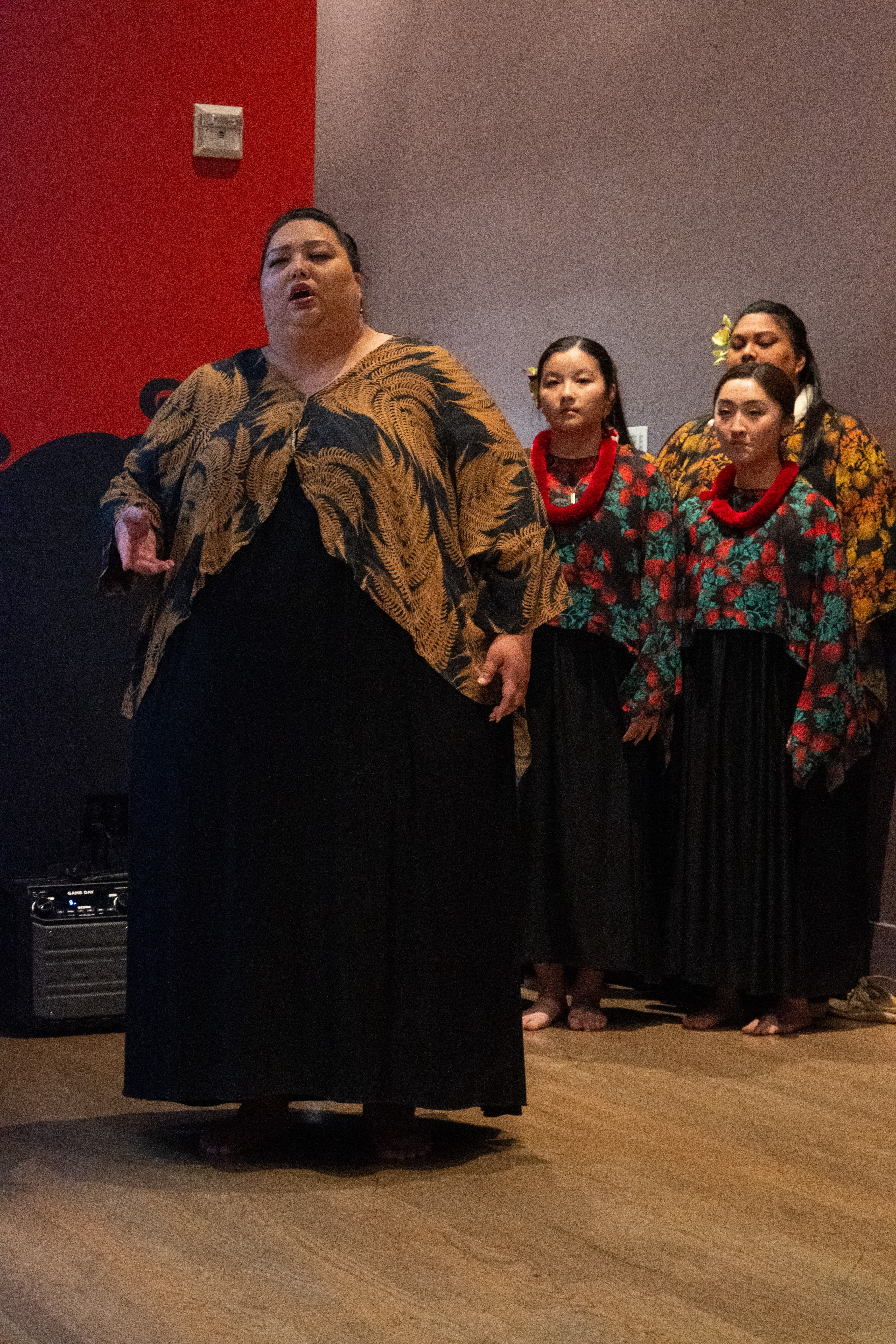 Kumu hula Leialoha Kaʻula and her students from Hālau Ka Lei Haliʻa O Ka Lokelani preparing to share hula at the *DISplace* opening reception at the Wing Luke Museum on June 14, 2025. Image courtesy Bruce Clayton Tom.
