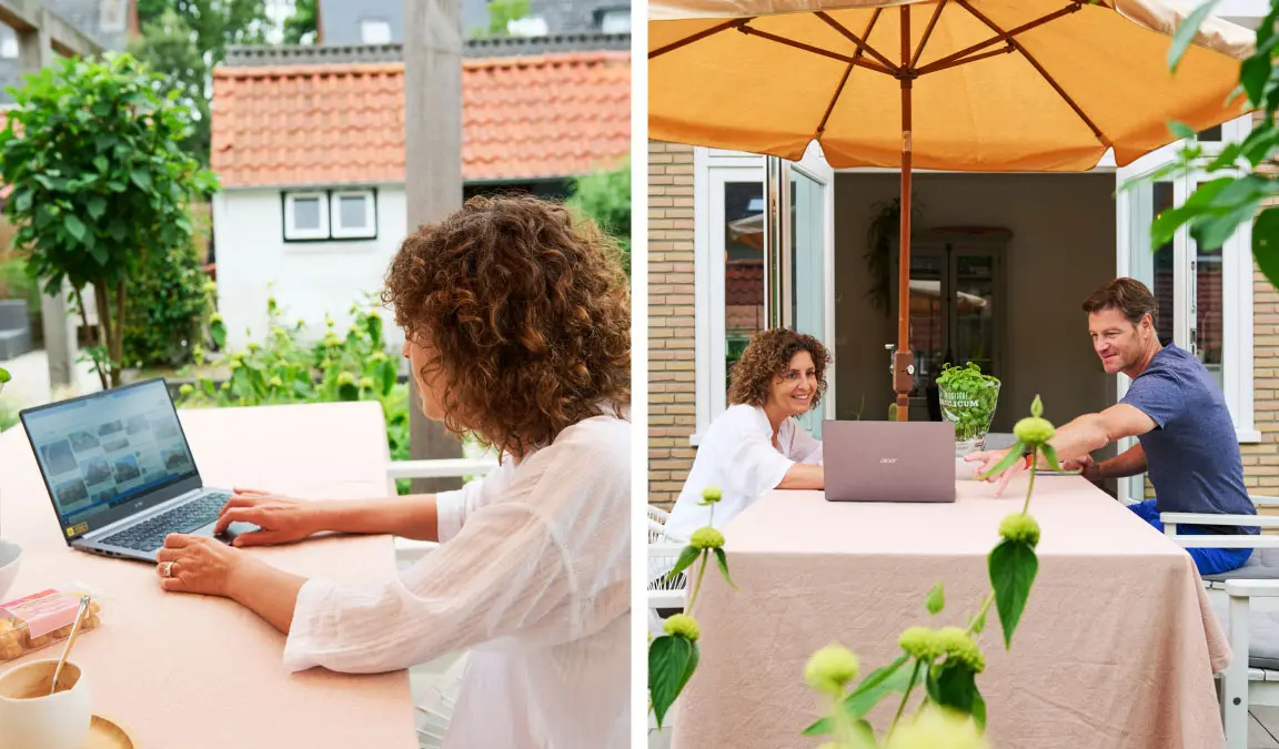 Nanda en Sjoerd zitten aan de tuintafel onder de parasol met een laptop op zoek naar een nieuw huis.