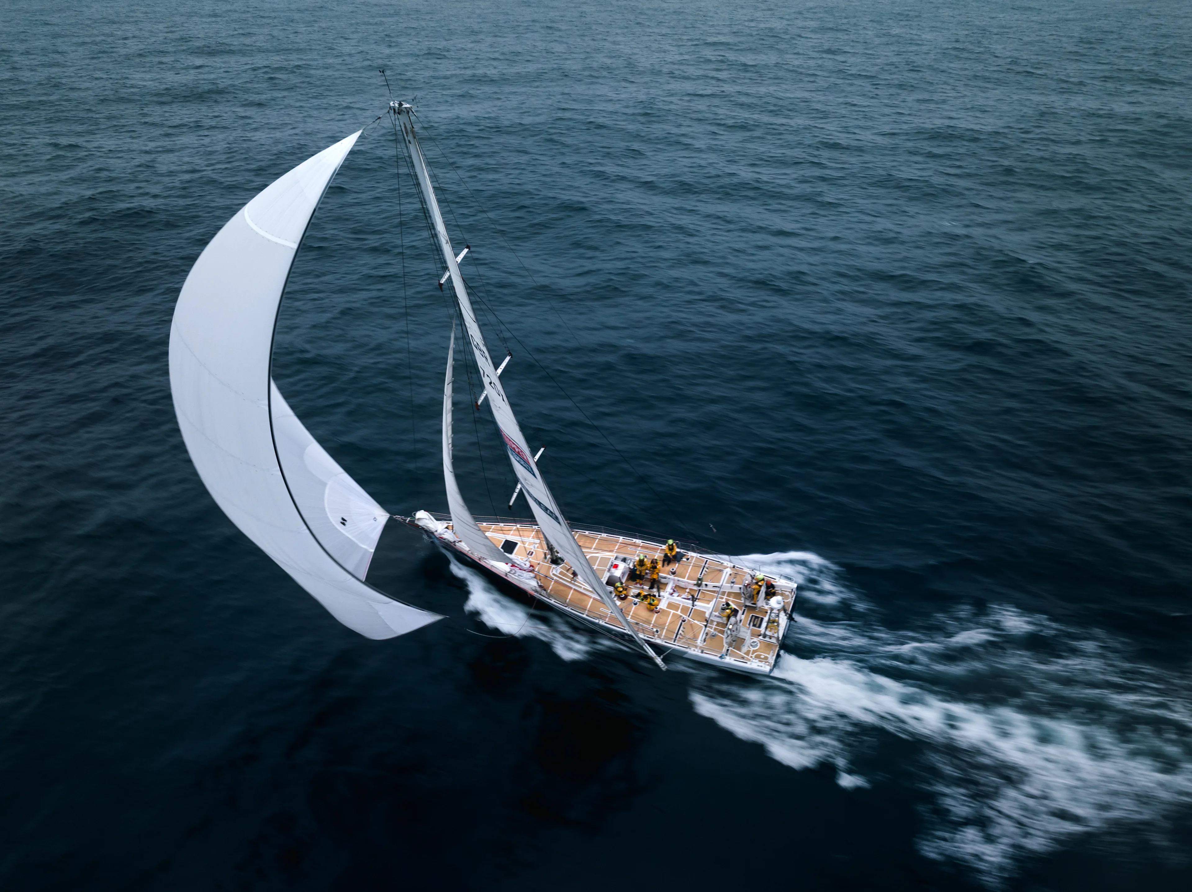 Drone aerial of a Clipper 70 ocean racing yacht heeled over and moving at speed under spinnaker during Leg 6: The Mighty Pacific.