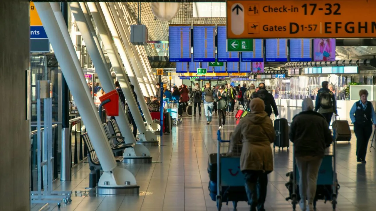 A busy holiday airport terminal, illustrating point.me's 2025 holiday travel forecast and tips.