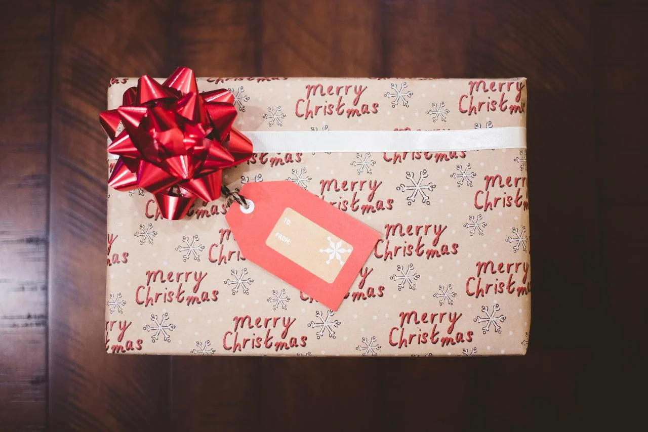 Holiday shopping bags beside a credit card, illustrating how to earn points toward a free flight.