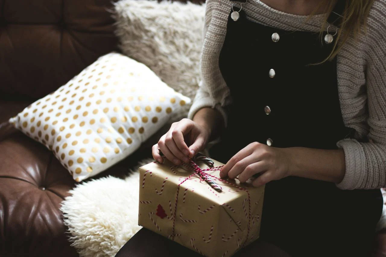 A wrapped travel gift with a boarding pass, illustrating creative ways to give a trip as a present.