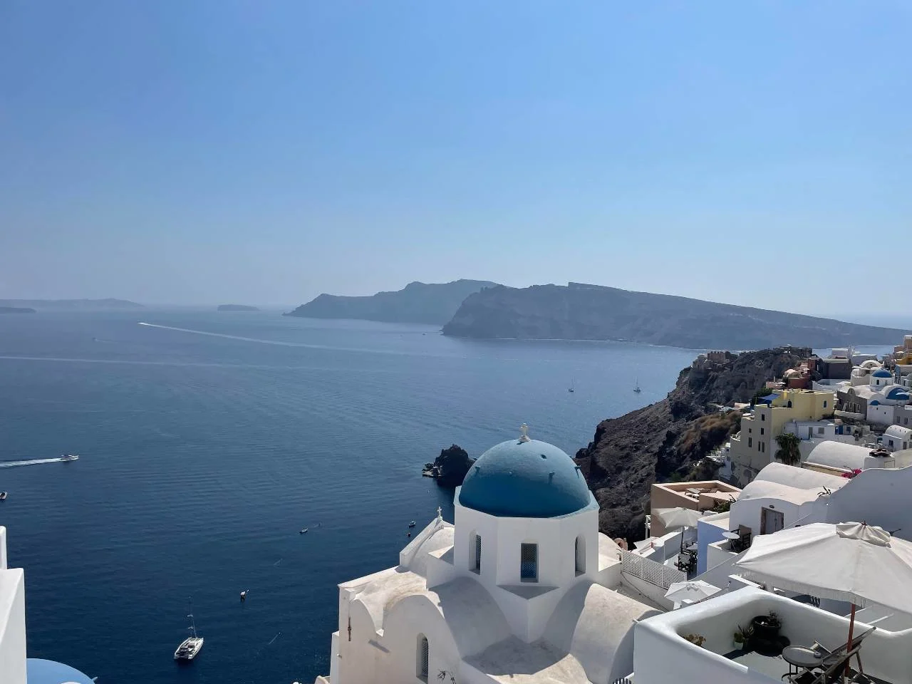 A couple at a Santorini overlook, illustrating how points funded a proposal trip and honeymoon.
