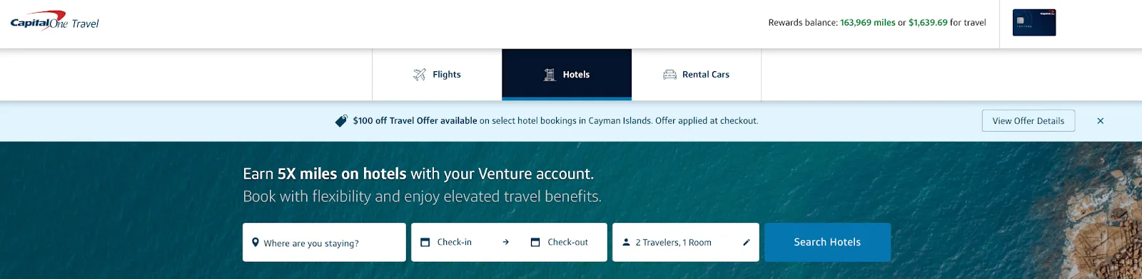 Screenshot of the Capital One Travel homepage on the Hotels tab, showing a $100 off offer for Cayman Islands bookings and a hotel search bar