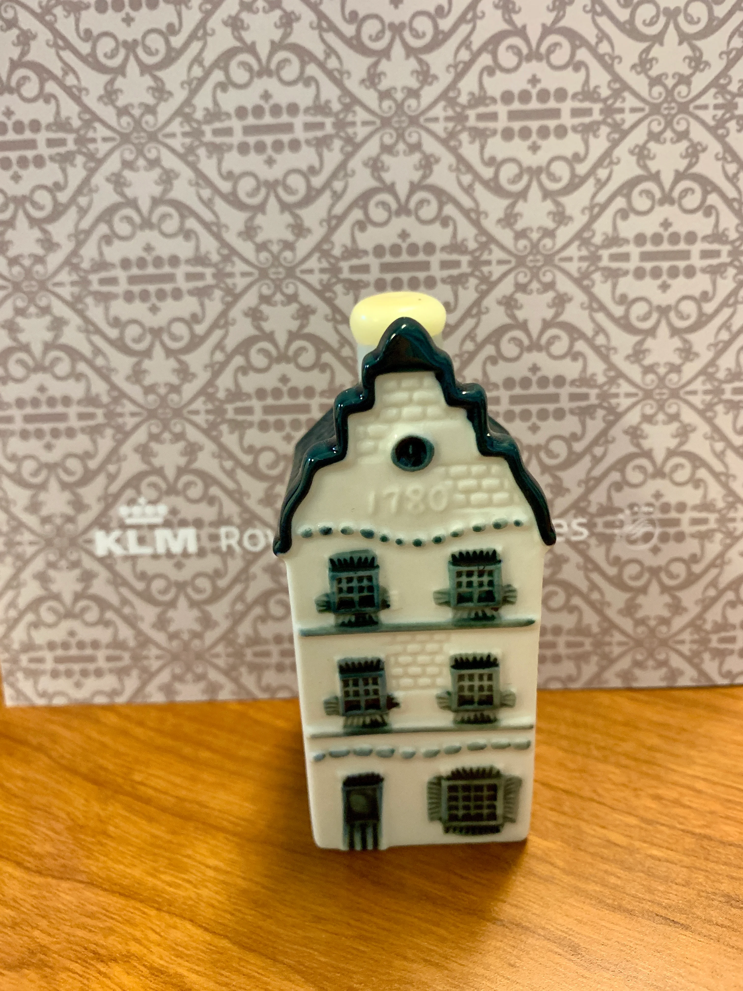 KLM Delft Blue miniature house, the airline's signature Business Class gift, displayed on a wooden table