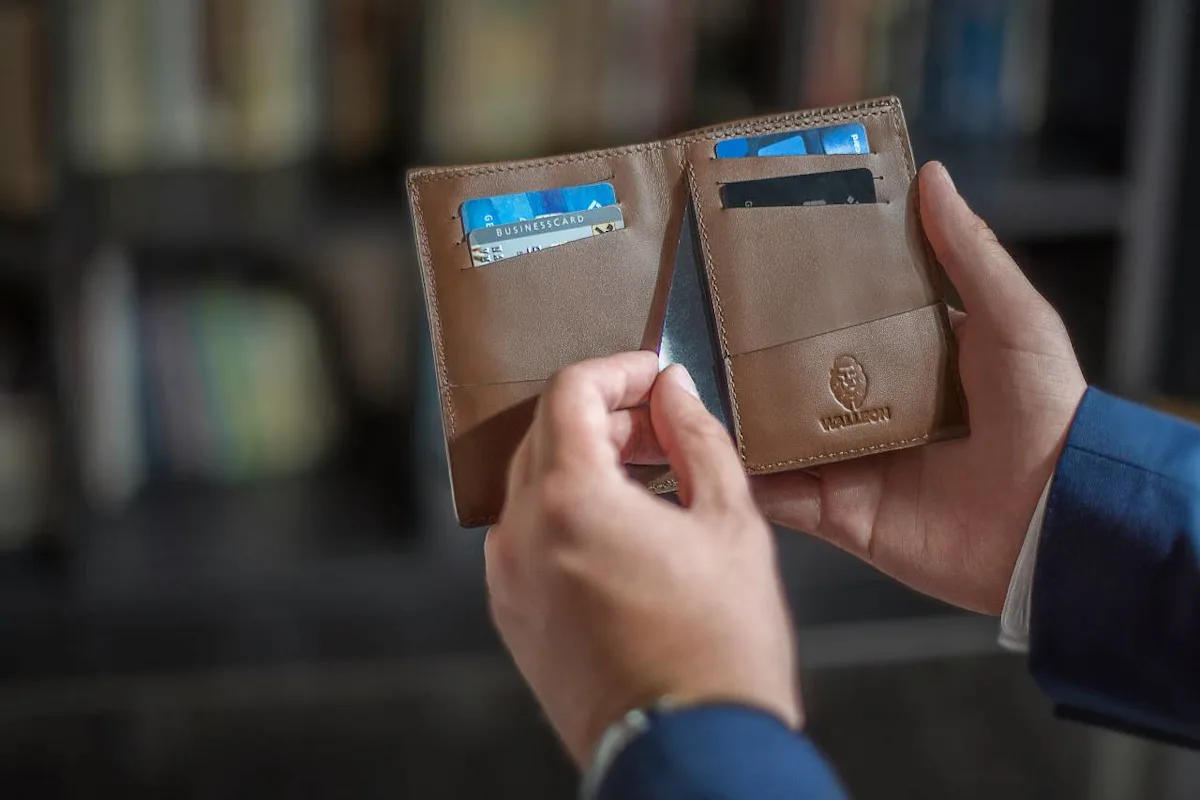 Airline co-branded credit cards beside a boarding pass, illustrating cards with free checked bags and priority boarding.