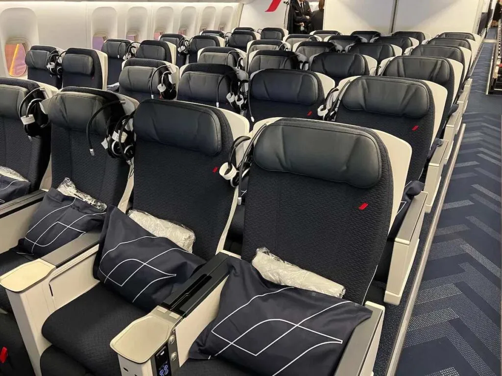 Rendering of Air France's new Boeing 777-9 business class cabin with white pod seats and personal entertainment screens