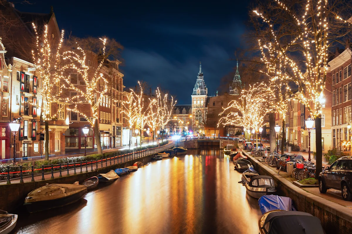Amsterdam's canal houses, illustrating a guide to the city's best hotels and restaurants.