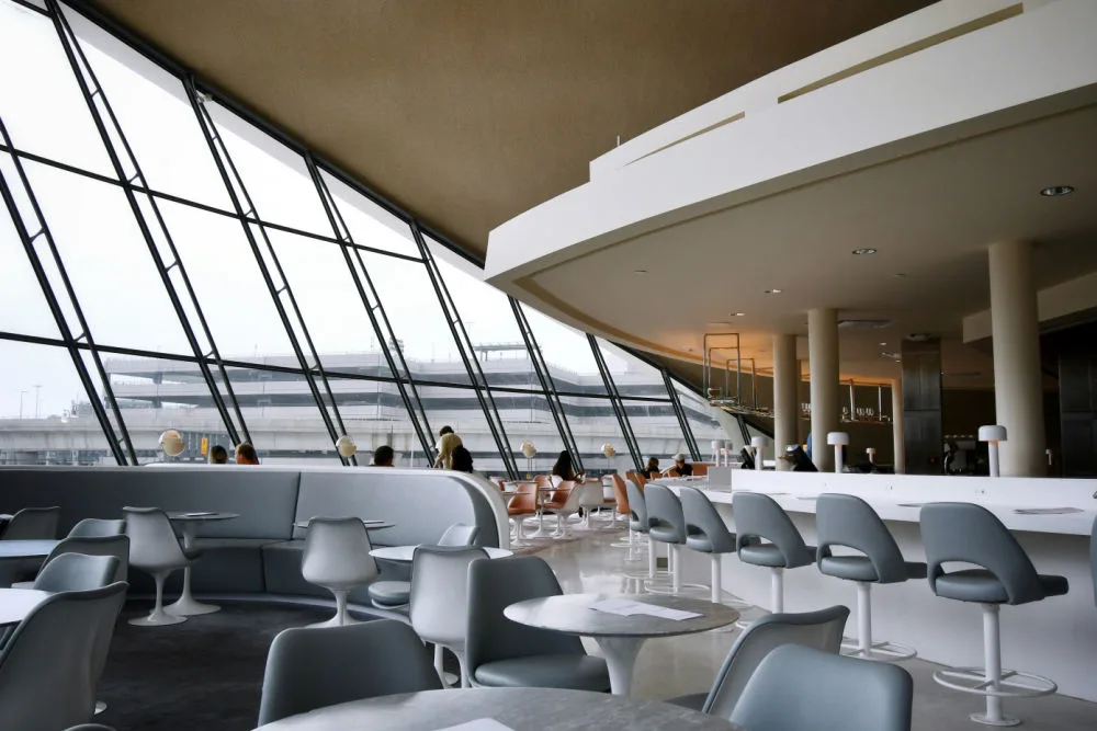 A calm, comfortable airport lounge interior, illustrating the best credit cards that include complimentary lounge access.