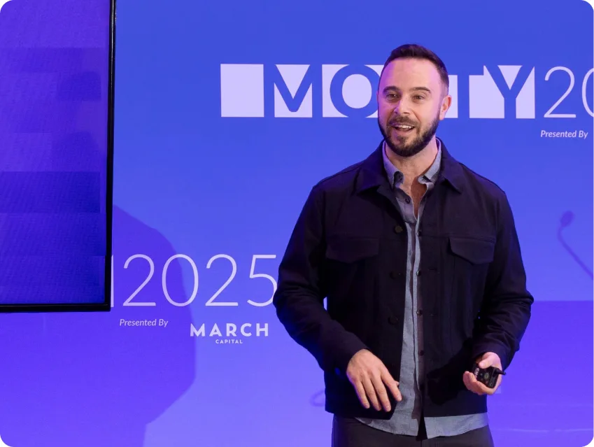 point.me Founder and CEO, Adam Morvitz, presenting at the MONTY 2025 Summit in March 2025 on stage.