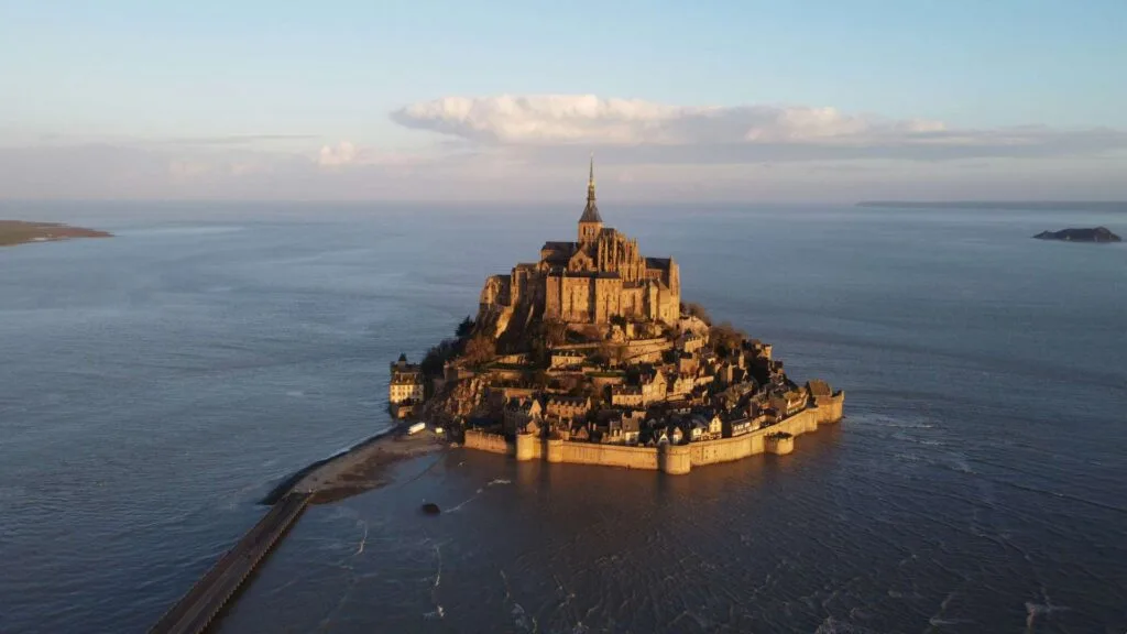 Aerial view of Mont Saint-Michel abbey rising from tidal flats in Normandy, France