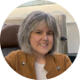 Andrea M. Rotundo, travel writer and rewards expert, headshot in an airplane first class