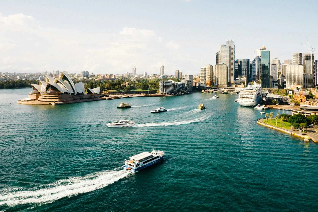 The Sydney skyline and harbor, illustrating how to fly to Australia on points and miles.