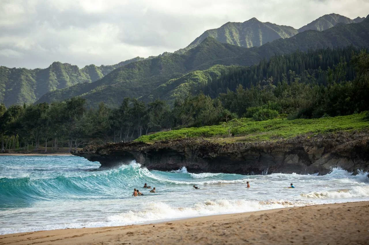 A Hawaiian Airlines aircraft over the islands, illustrating how to book Hawaiian flights with points.