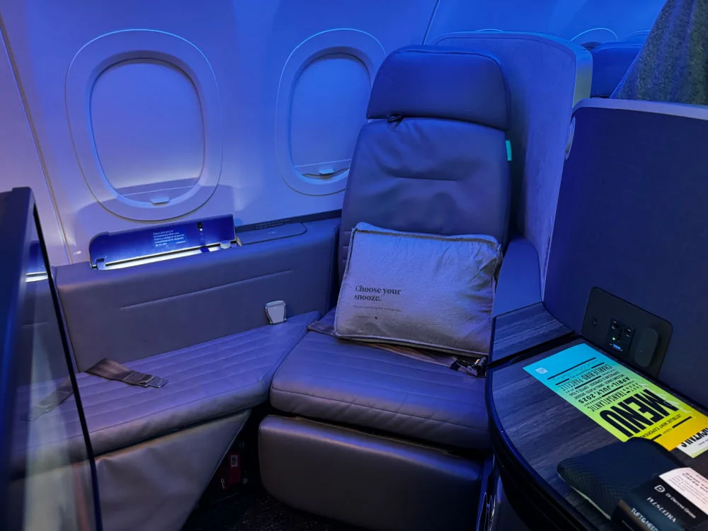 A JetBlue Mint suite with a lie-flat seat, illustrating how to fly JetBlue Mint business class for less.