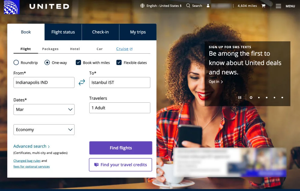 Screenshot of the United Airlines homepage with a one-way flight search set from Indianapolis to Istanbul, alongside a promotional photo of a woman checking her phone.