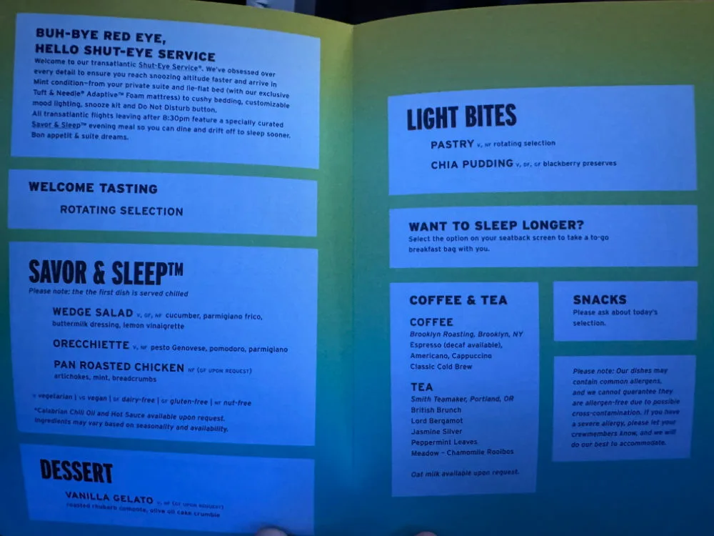 Open JetBlue Mint in-flight menu listing the Savor & Sleep evening meal, light bites, and coffee and tea options for a transatlantic flight