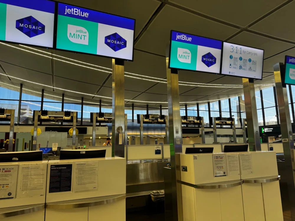 JetBlue Mint and Mosaic check-in signage above self-service kiosks at Boston Logan Airport