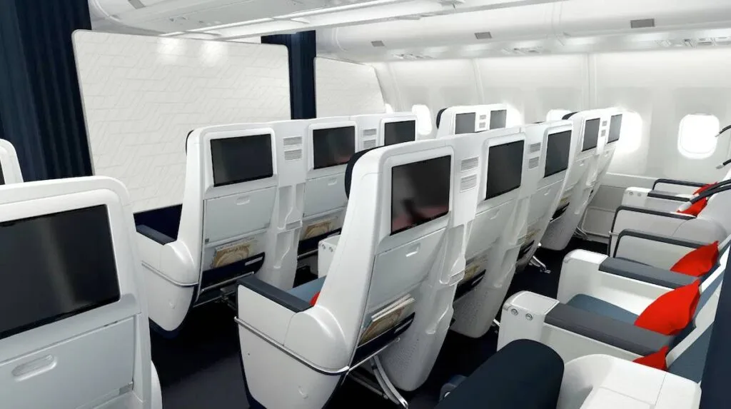 Rows of Air France premium economy seats with headphones and dark blue pillows in the cabin