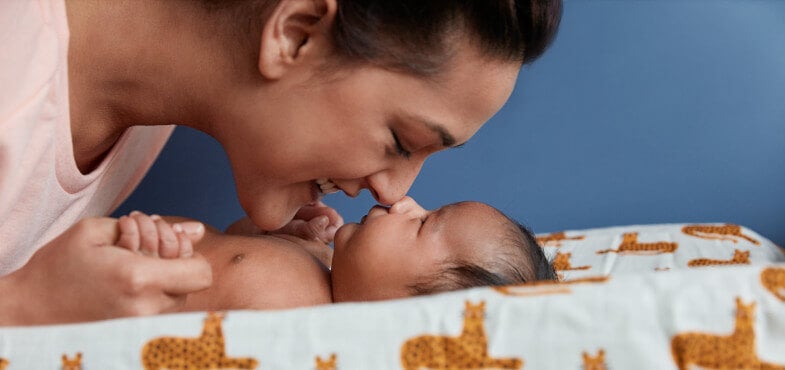 Mom and newborn touching nose to nose 