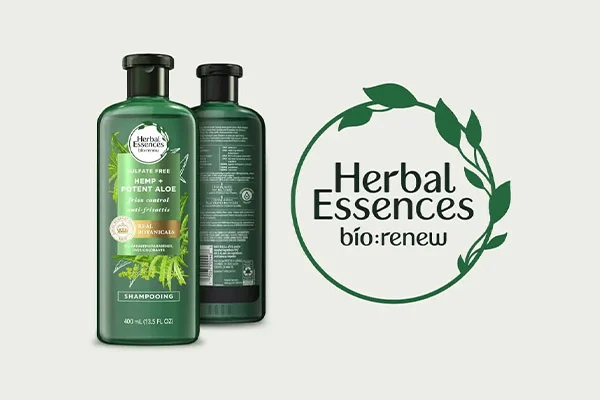 Two green bottles of shampoo and conditioner. Next to the bottles is a green logo with text that says "Herbal Essences bio:renew."