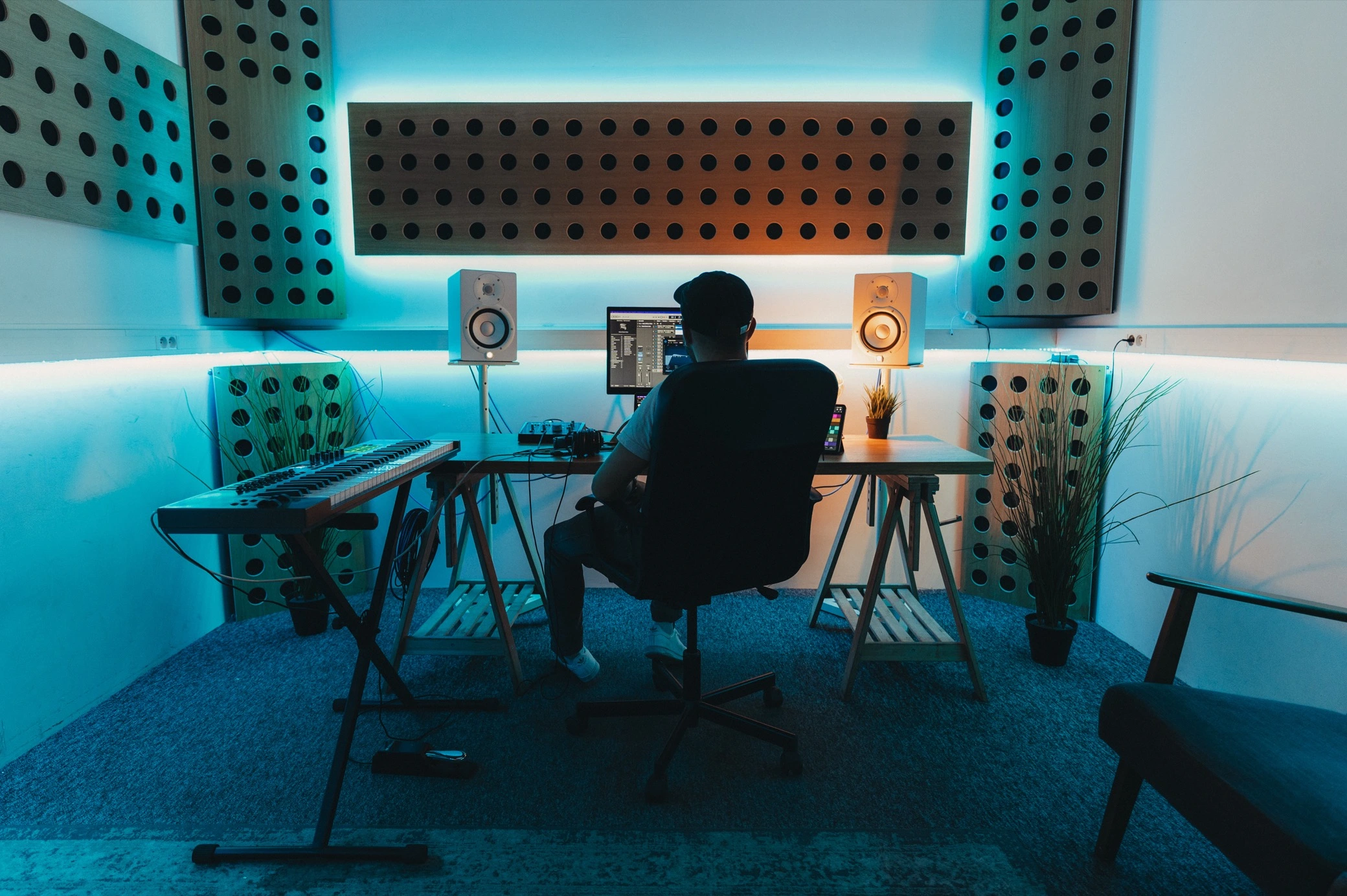 Photo of artists producing and playing in a beatmaking studio