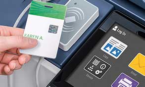 Hand holding ID card over MFP user interface