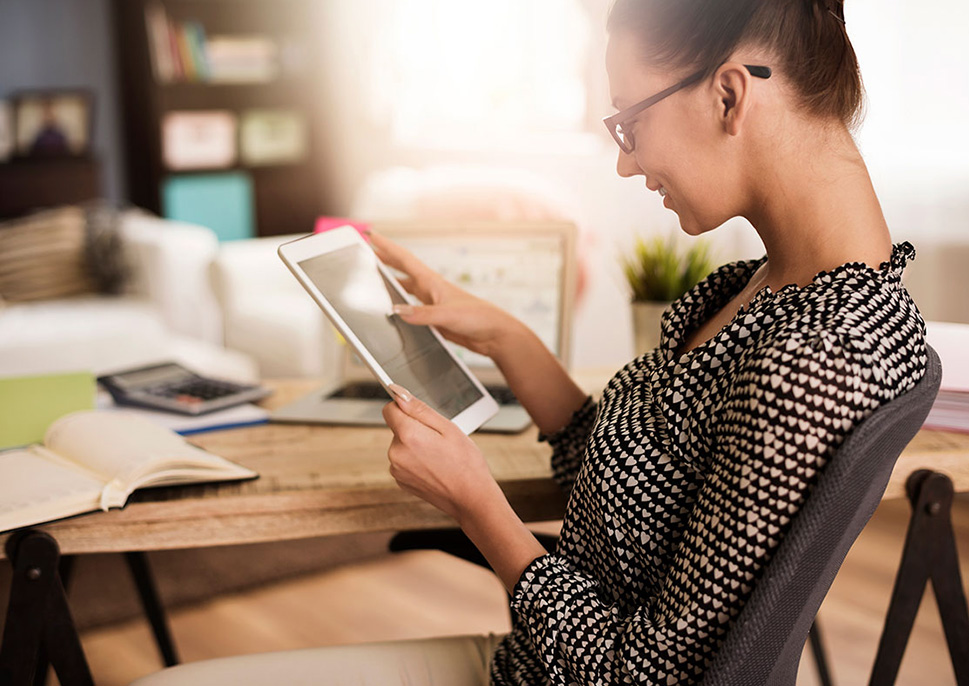 woman in an office using a tablet