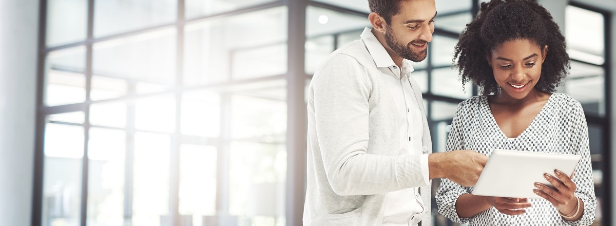 man and woman looking at smart tablet