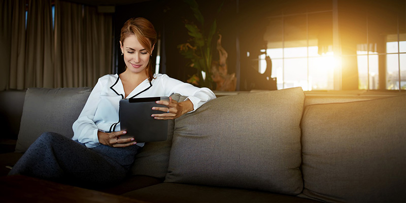 woman sitting holding tablet