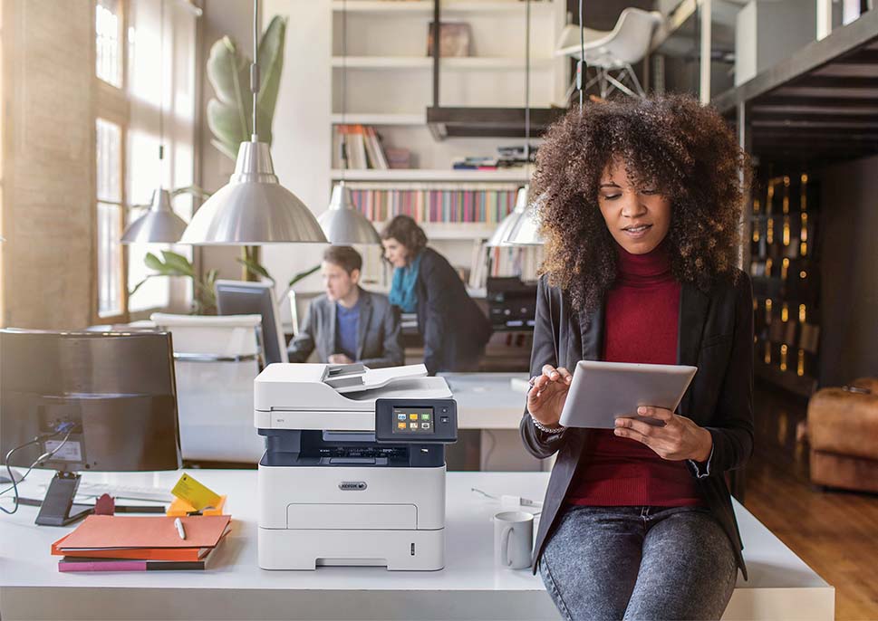 女人在办公室在Xerox B215打印机旁边威廉希尔公司官网
