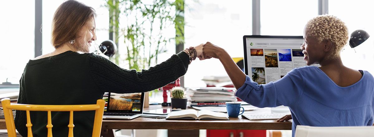 Two colleagues doing a fist bump