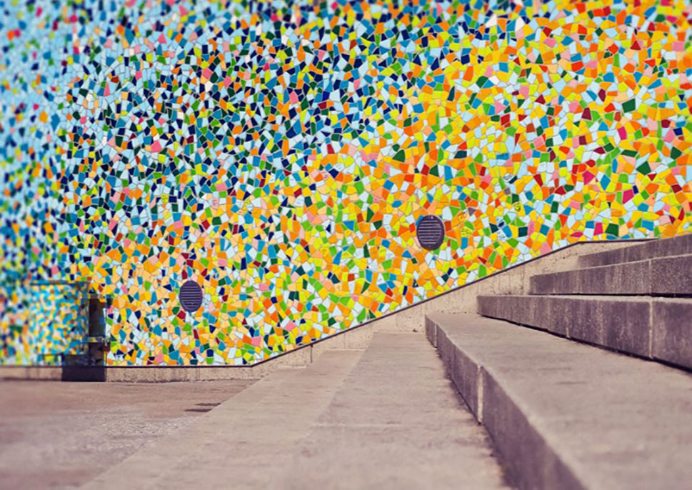 Outdoor stairway with colorful mosaic on the wall