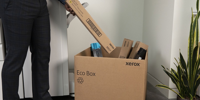 Man putting cartridge into Eco Box for recycling