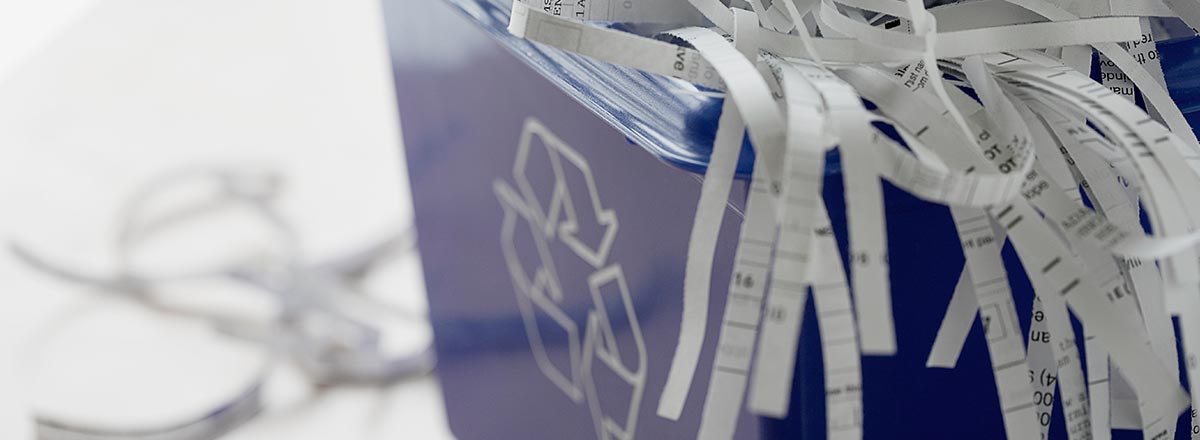 Recycle bin full of shredded paper