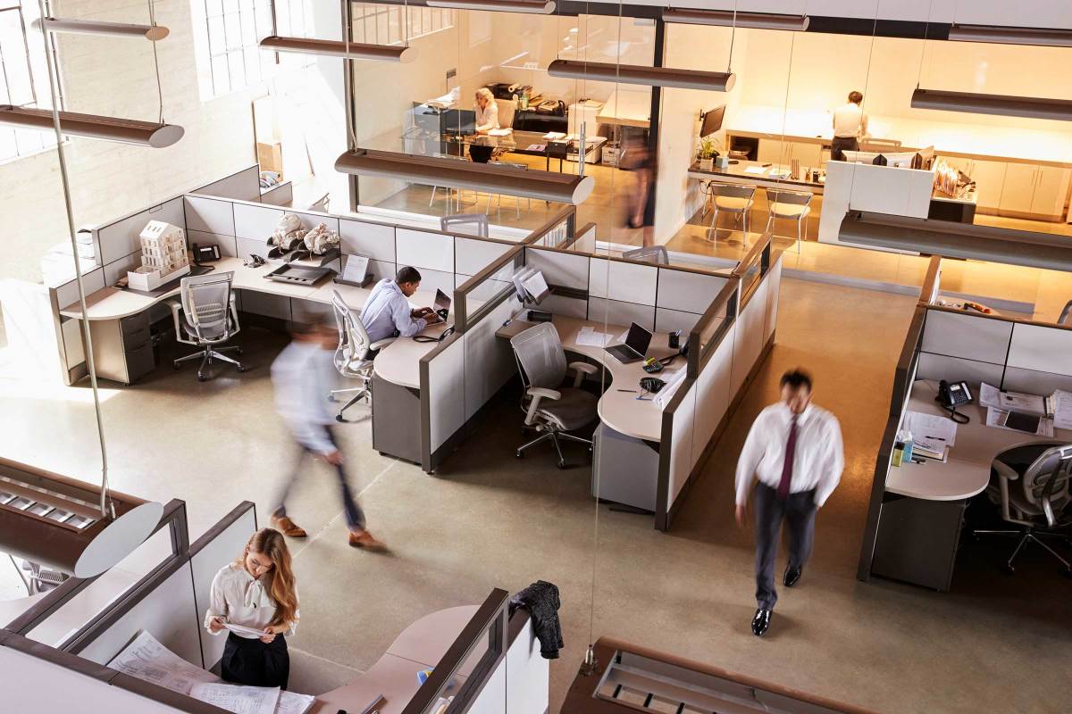 Busy, fast paced office. People walking are blurred.