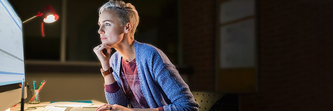 Person in a dark room using a computer