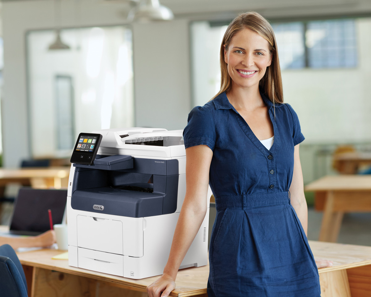 Smiling woman in front of Xerox VersaLink B405 MFP