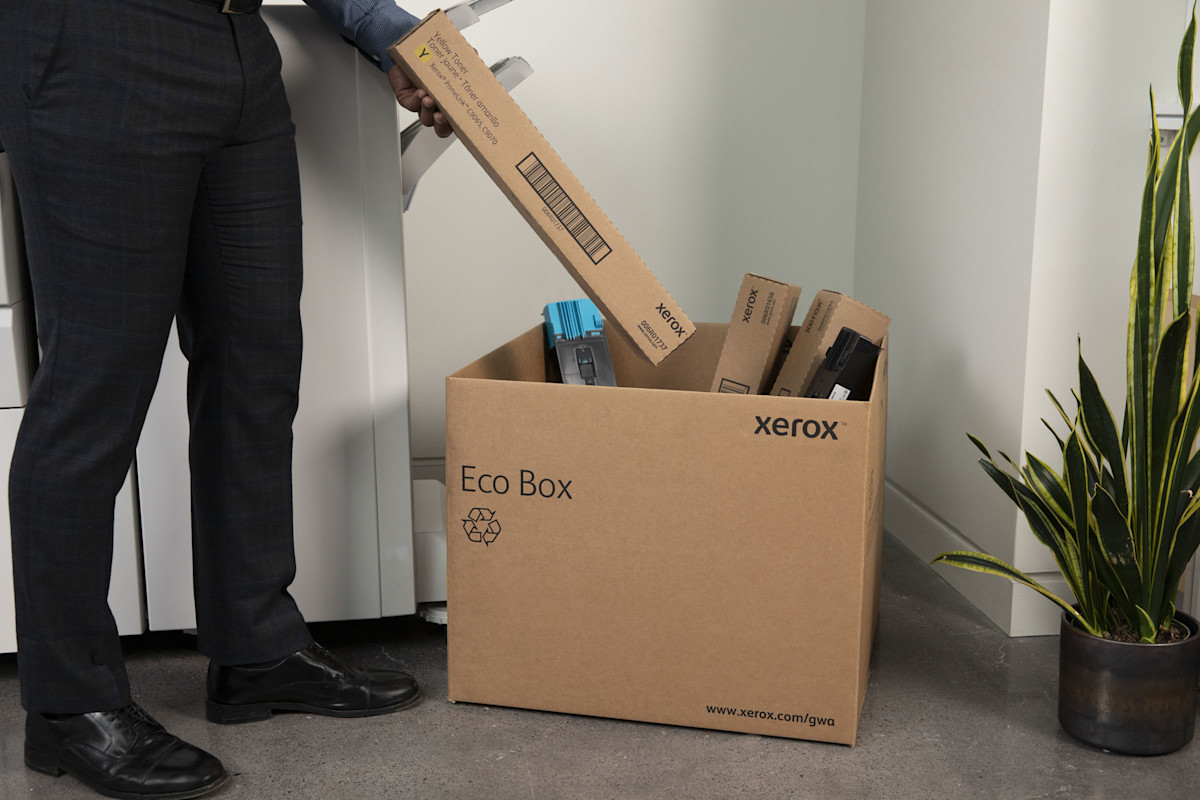 Man putting cartridge into Eco Box for recycling