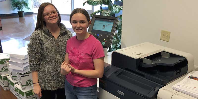 Two students from Reno Schools standing next to their Xerox PrimeLink printer