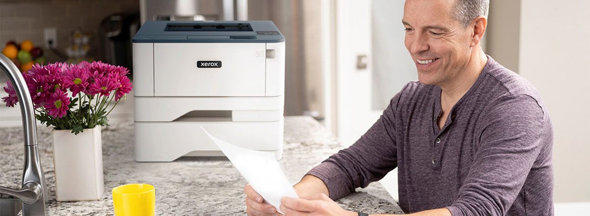 man using xerox versalink printer in home remote office