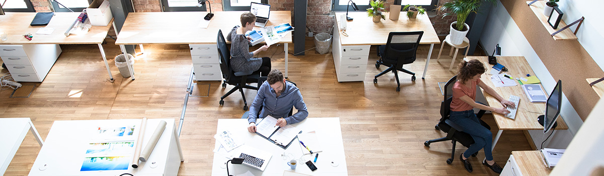Open office with 3 people working at desks
