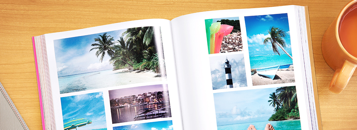 Bound book open to a page of pictures of a tropical vacation