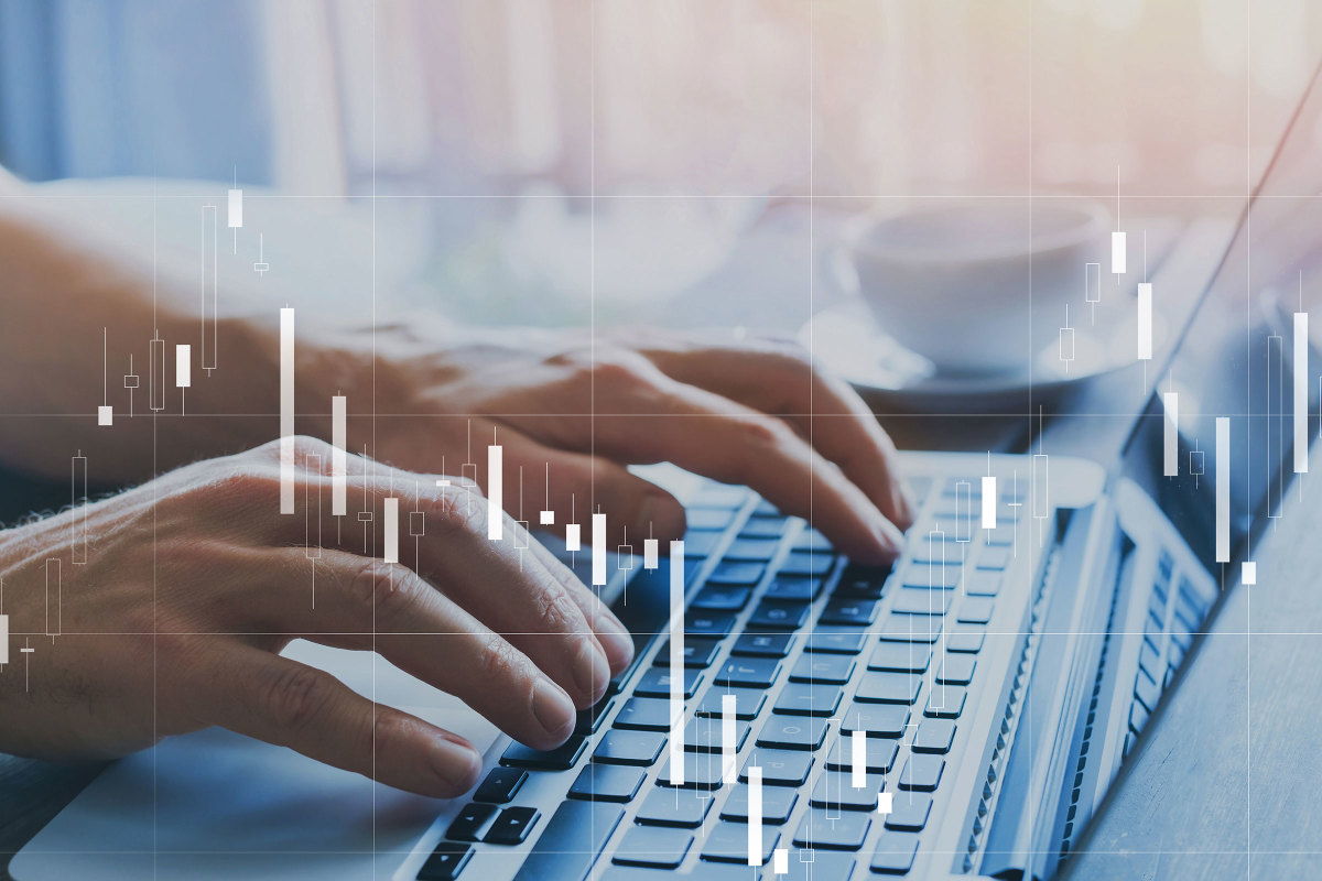 Hands typing on a laptop keyboard, overlaid with flowchart symbols