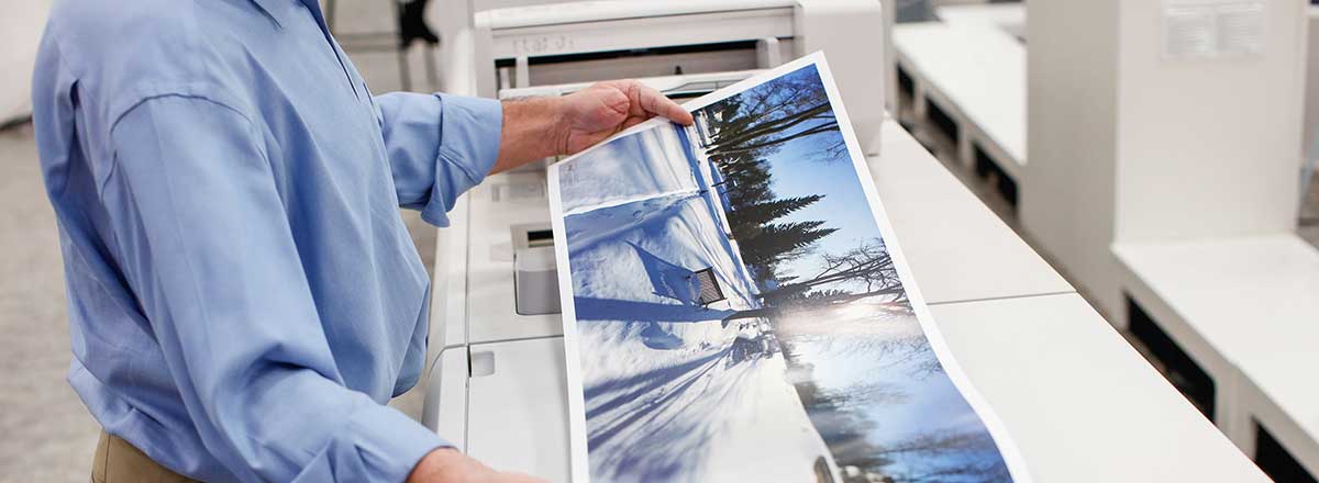 Printer holding an extra long sheet banner, printed with the Xerox® High Capacity XLS Vacuum Feeder