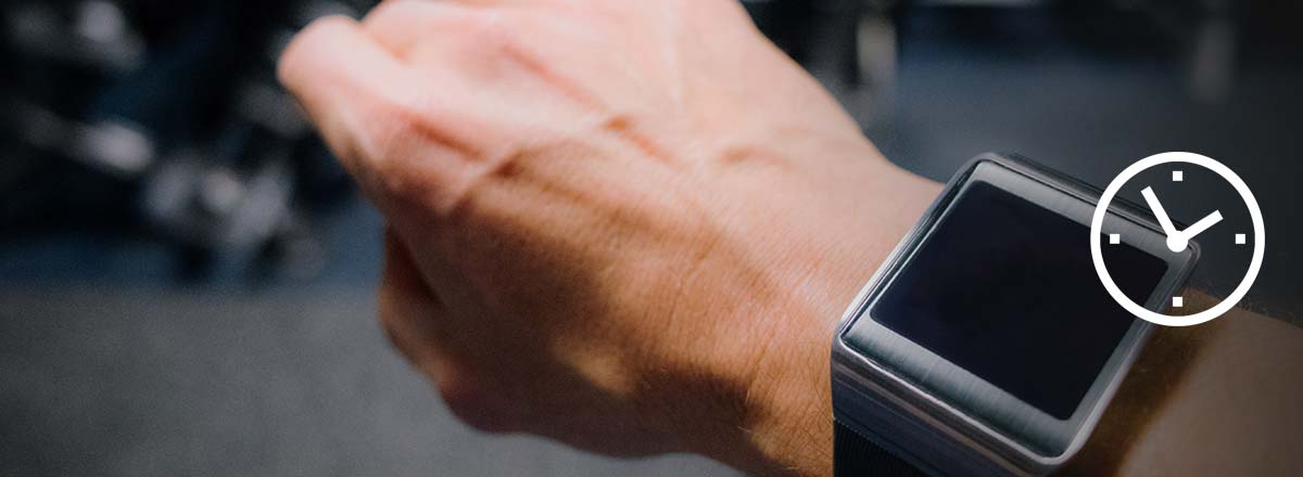 Hand with a smartwatch, overlaid with a clock icon