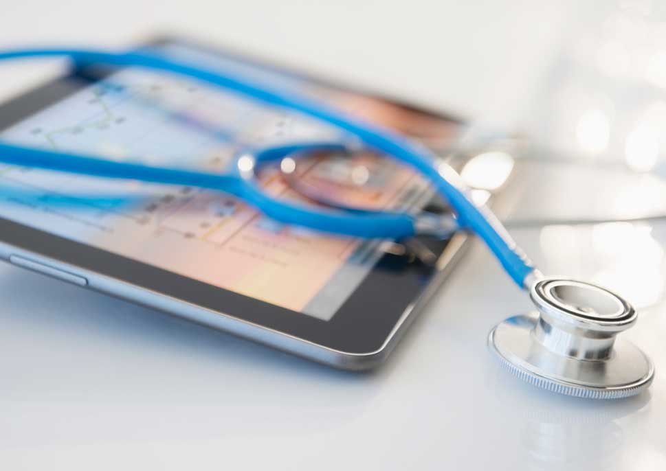 stethoscope laying on top of a tablet
